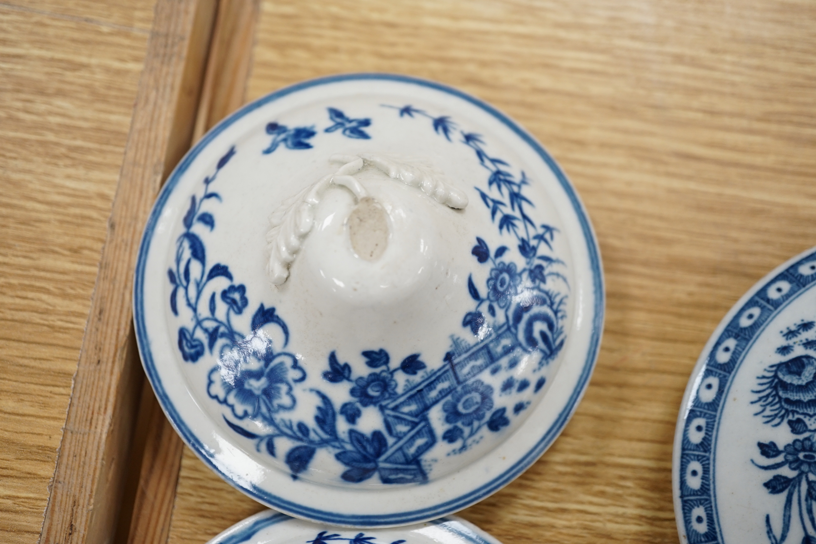 A 19th century Abbotsford pattern blue and white tureen and cover, various dishes and a collection of early Worcester tea and coffee pot covers